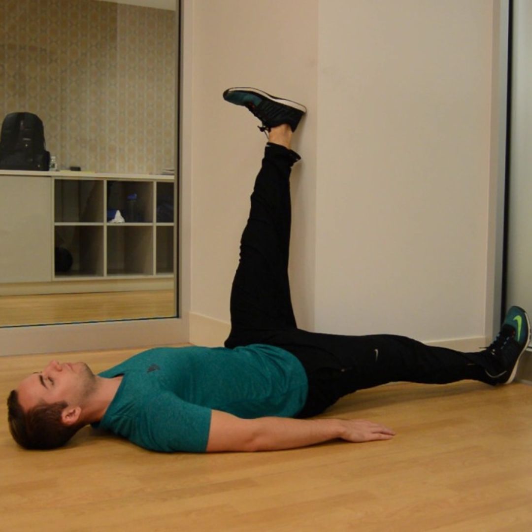 a human doing Wall Hamstring Stretch
