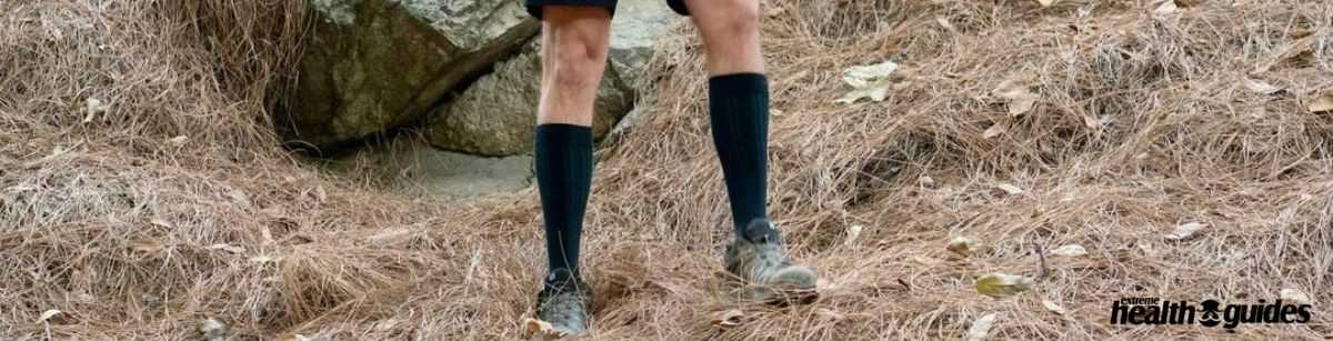 a human wearing Compression socks and standing on the ground